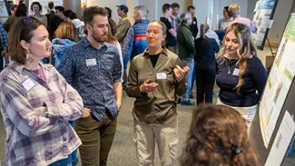 Students share a poster board presentation of their capstone design project