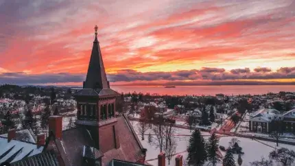winter sunset over buildings and lake