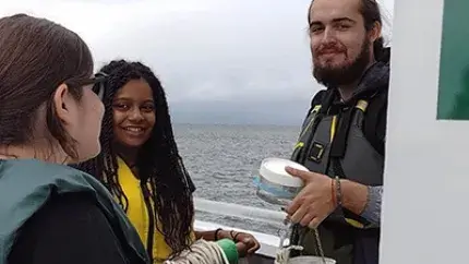 LASP students talk on a boat during a field-based learning experience.