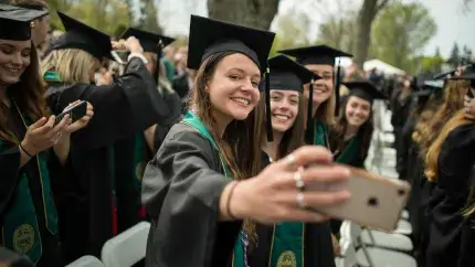 Graduates take a selfie.