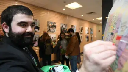 man putting a pin on a map