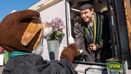 Computer Science 2026 graduate Levi Paré shares a creemee with Rally before the CEMS Commencement