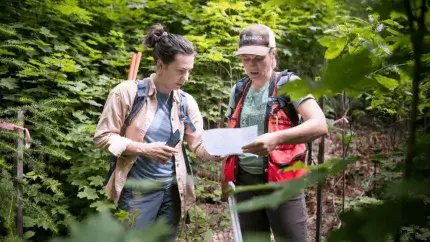 Two people looking at a clipboard
