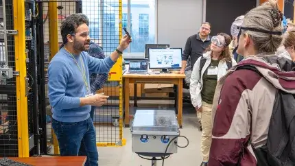 A graduate student provides a facilities tour to visiting vips