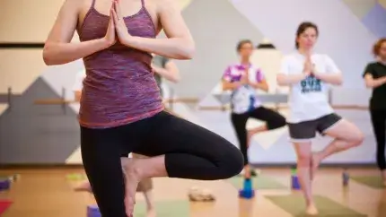 Standing Tree pose on one leg in a yoga class