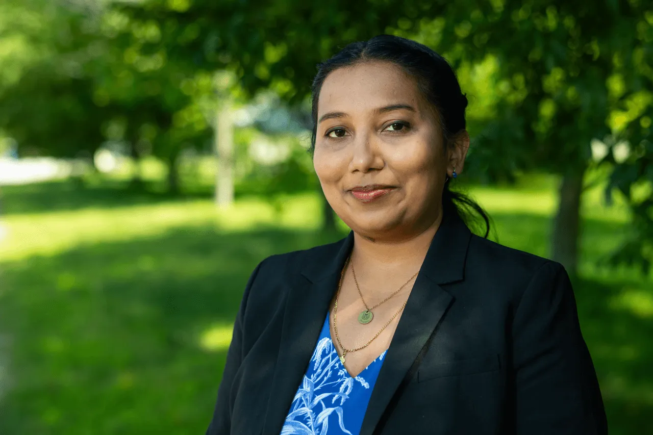 Photo of Faculty Trishnee Bhurosy with grass and trees behind