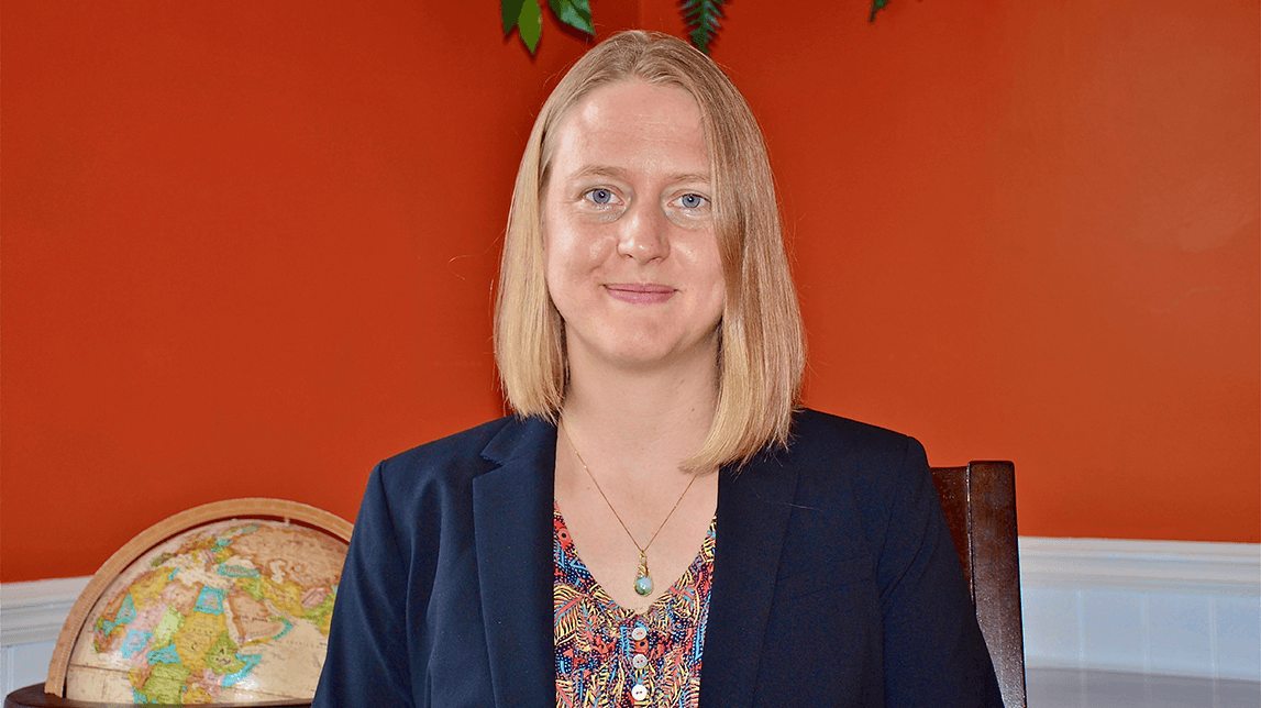 Ingrid Nelson, smiling in a brightly painted room