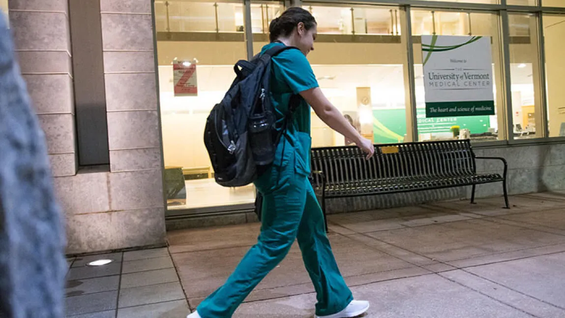 Nursing student walking to clinical rotation in hospital
