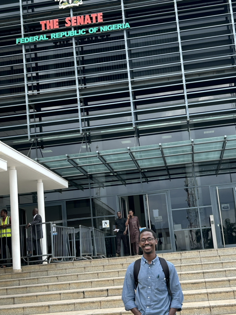 Man standing in front of Nigerian Senate
