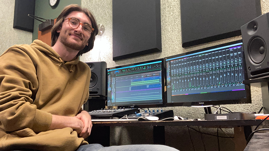 Pat in a sound studio with speakers and computers with monitors