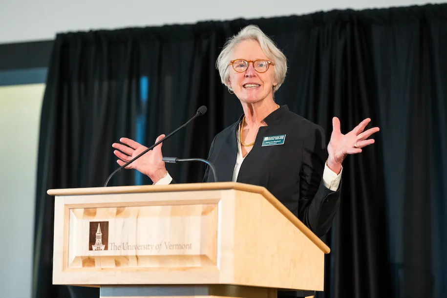 Katie Shepherd speaks at the podium at UVM's Outstanding Educators Day in November 2022.