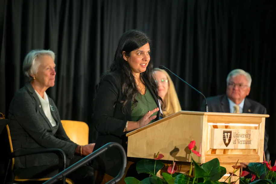 Aziza Malik speaking at the podium