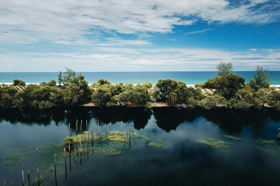 A photograph of a flooded seaside area in Malaysia