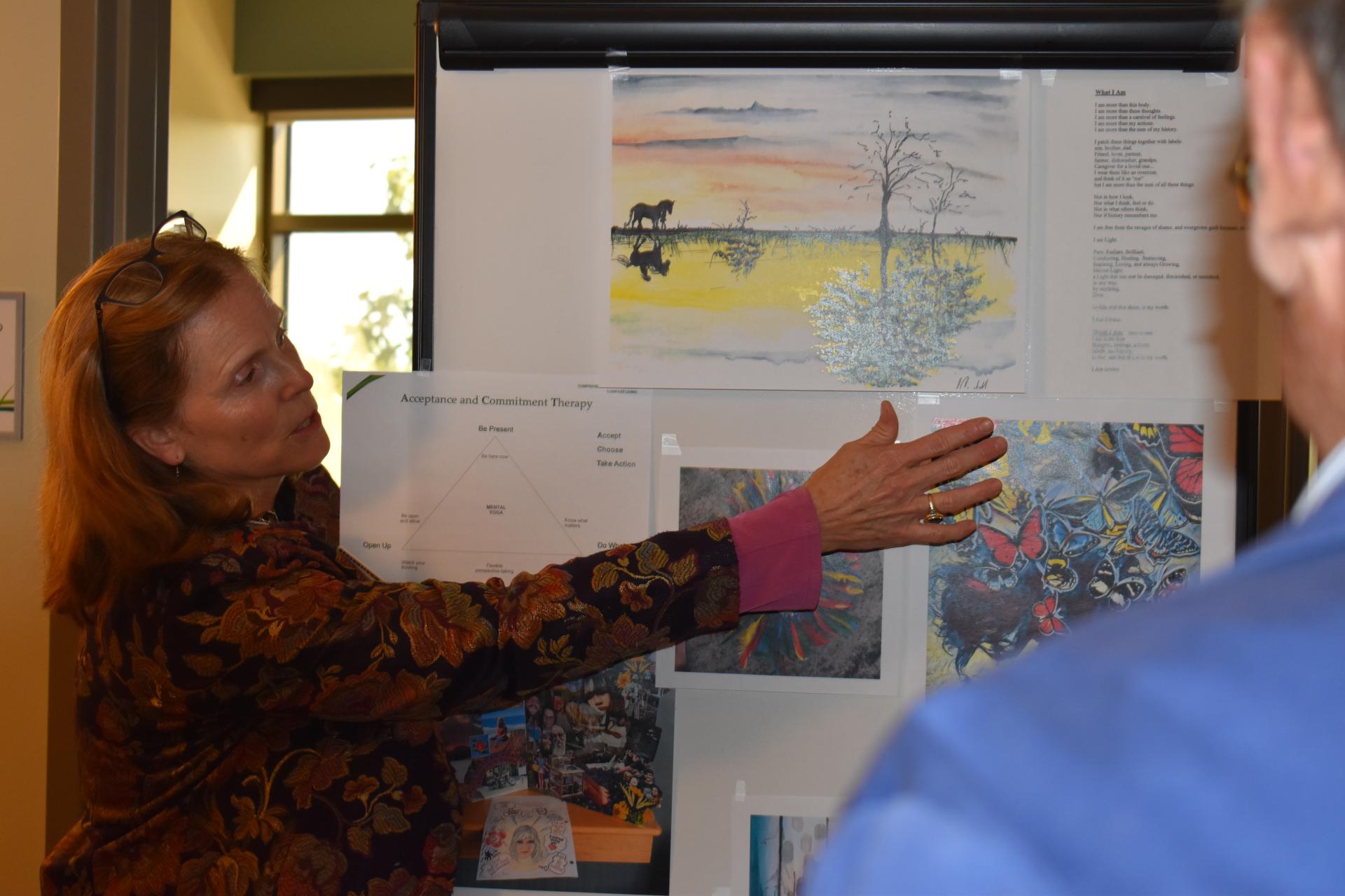 person pointing to poster