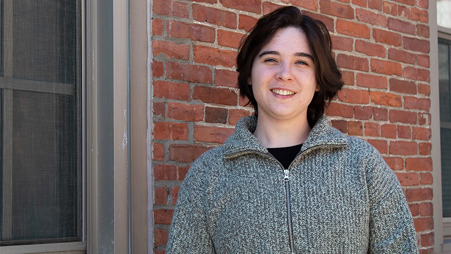 A lovely smile on Fiona's face as she's standing next to a brick wall