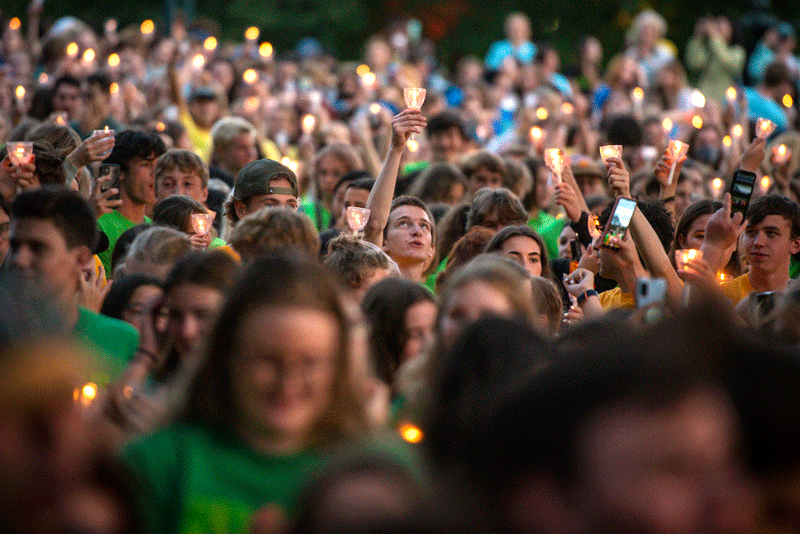One candle stands out in a crowd of candles.