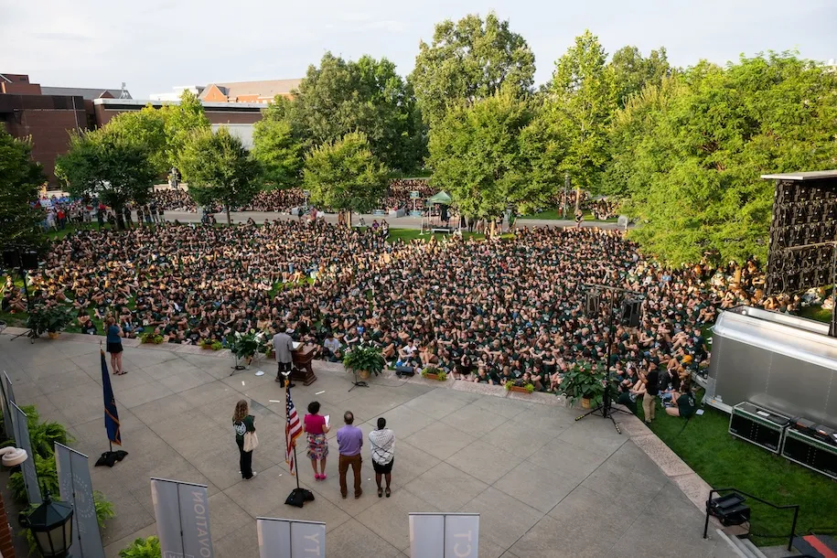 Crowd of students sitting in front of Harris Commons stage