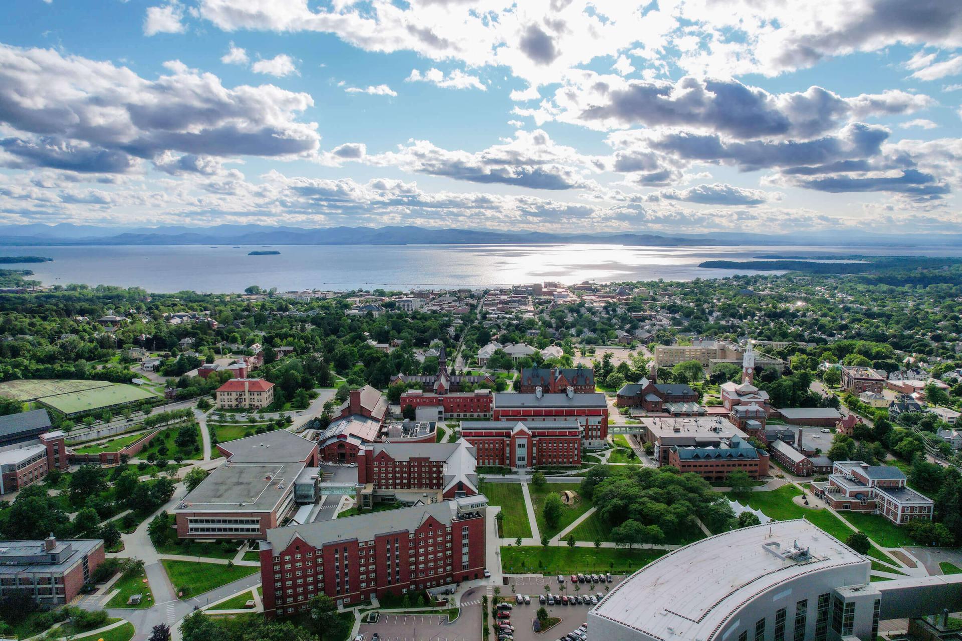 Campus overhead shot with downtown Burlington, Lake Champlain, and the Adirondacks in the distance.