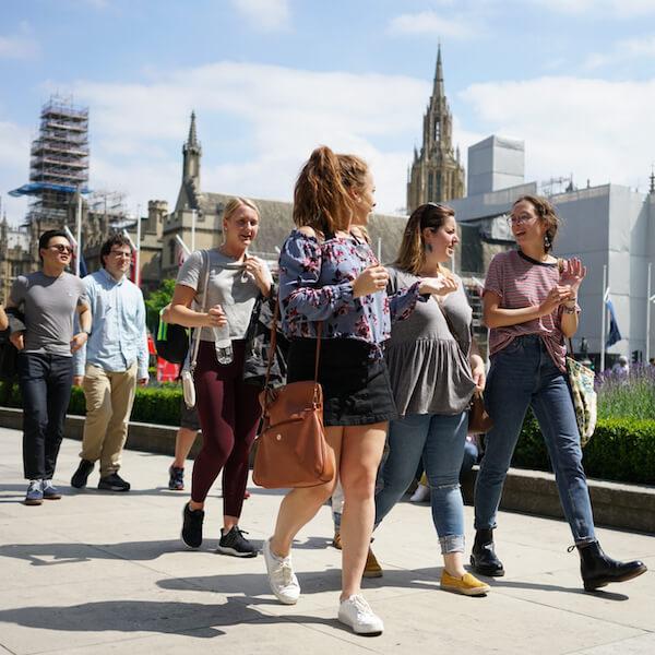 Students walk down a London street.