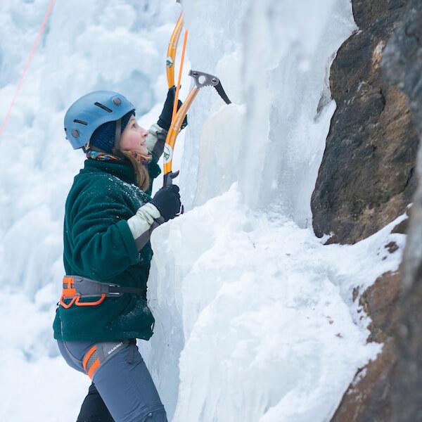 Person in the process of ice climbing