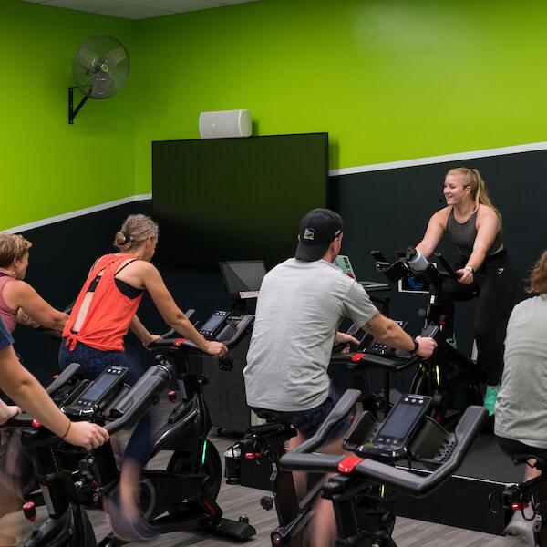 People in cycling studio riding bikes