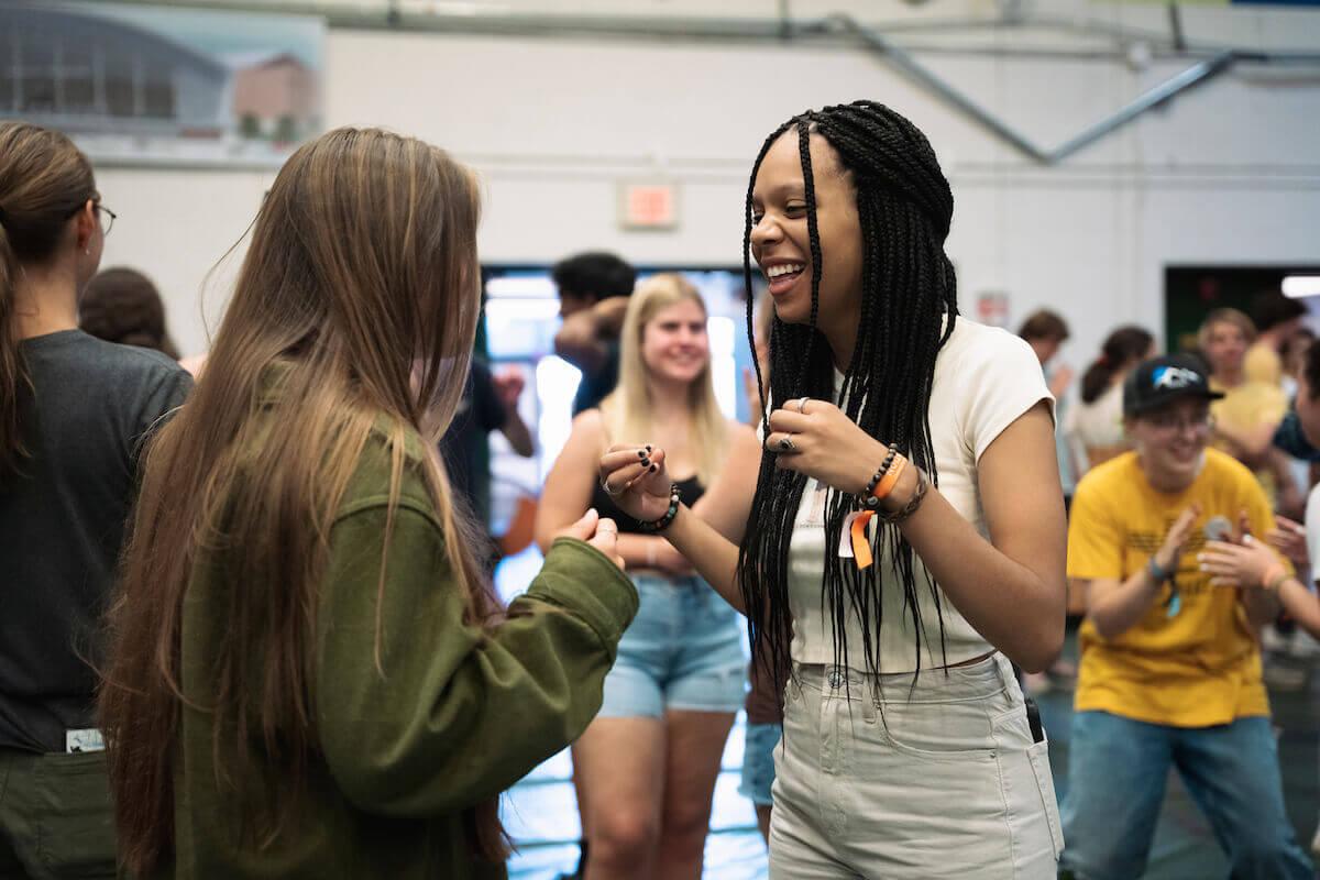 Two students laugh while having a conversation