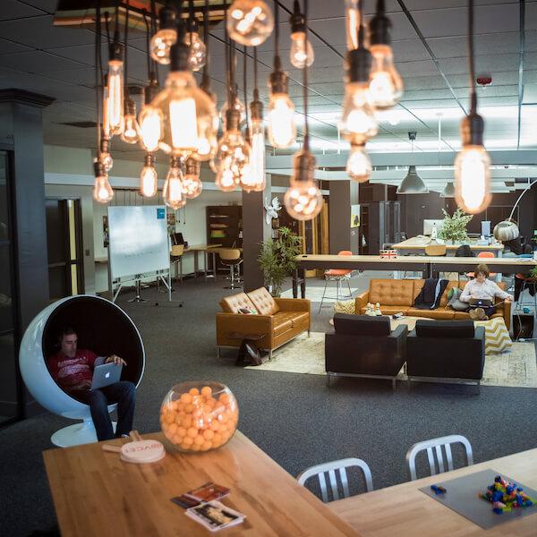 An intern relaxes in a high-tech collaboration space.