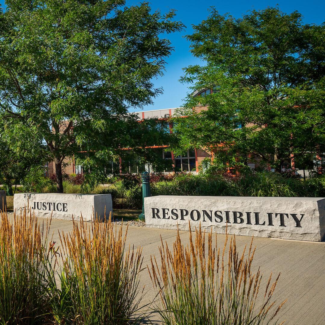 Stone blocks embossed with the words justice and responsibility.