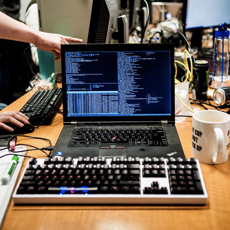 a computer and keyboard with code on the screen