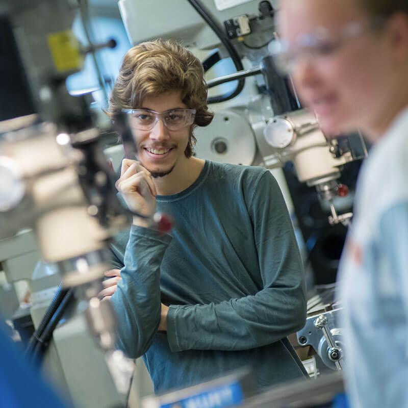 student looks at machinery