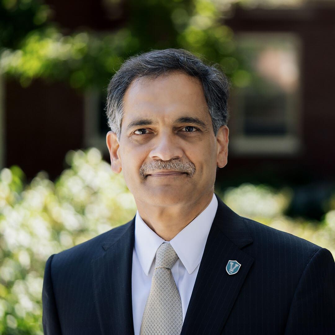 portrait of suresh with trees in the background