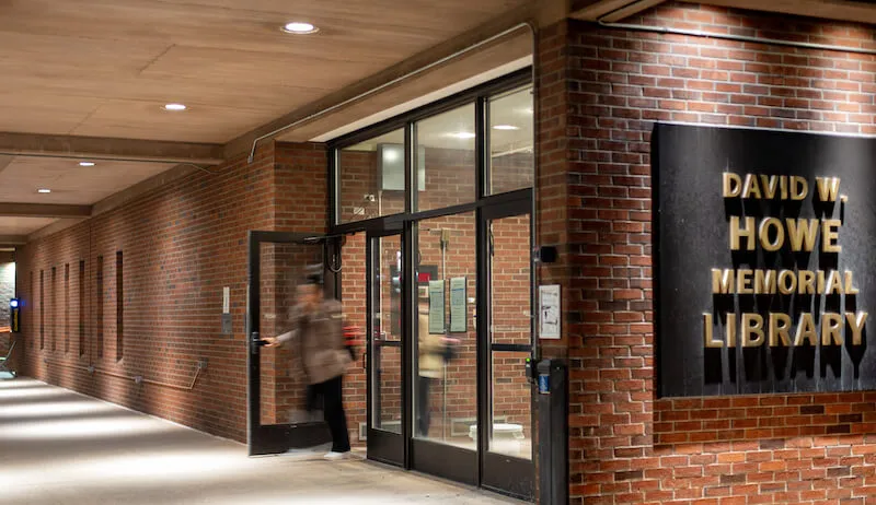A student exits the Howe Library.