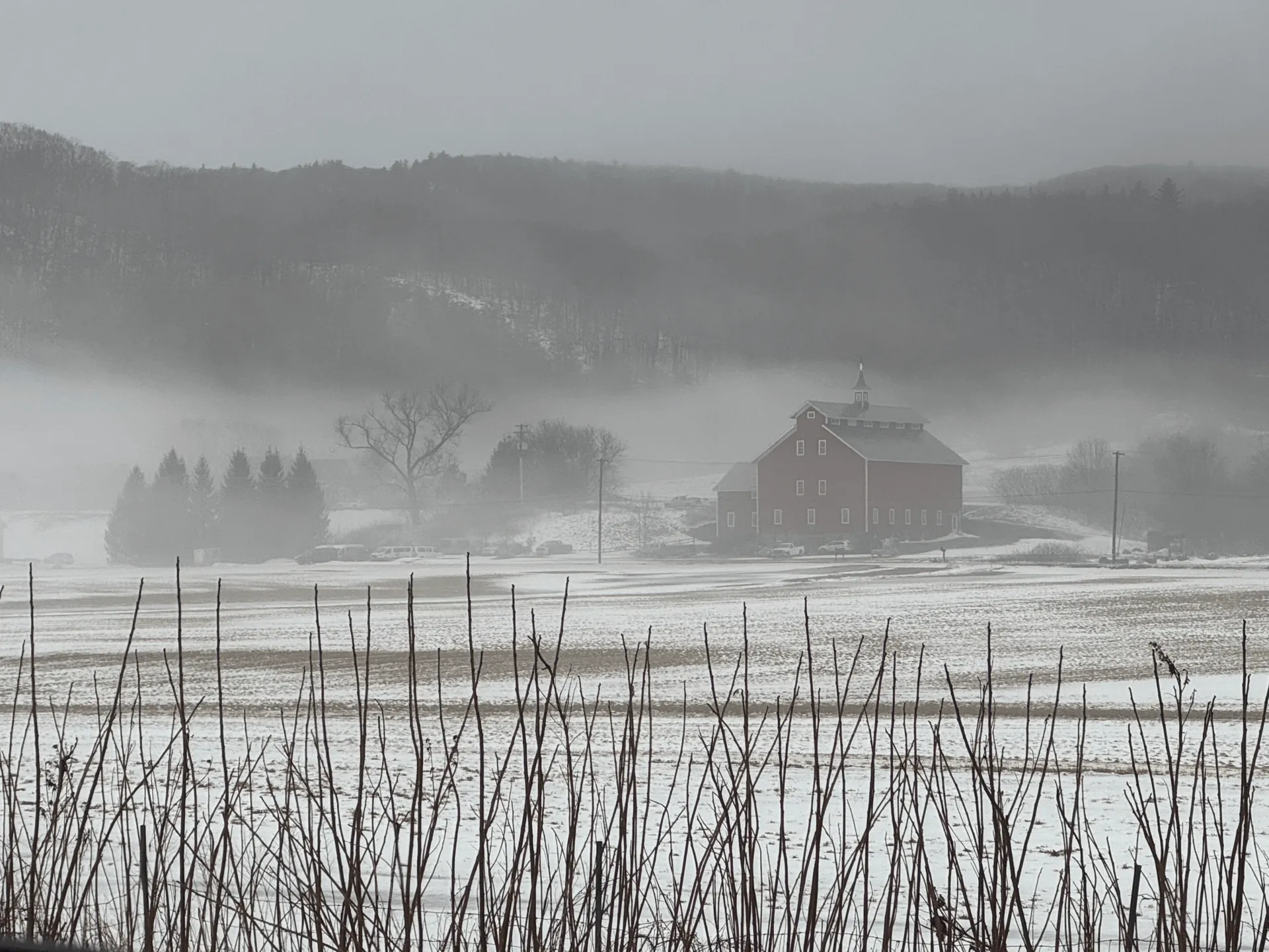 Historic barn in a field covered with snow