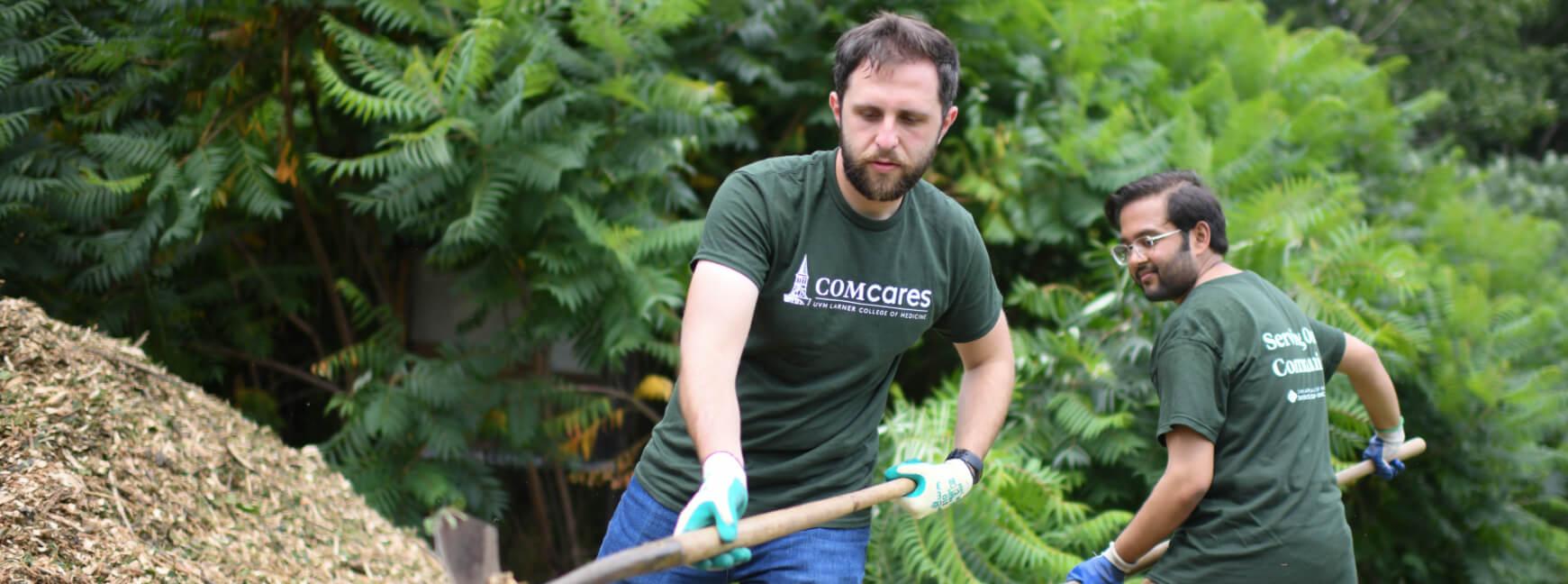 Two med students working in community gardens