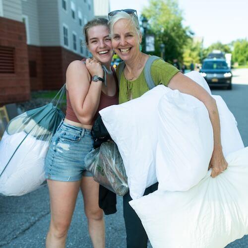 A mother and daughter smiling on move-in day.