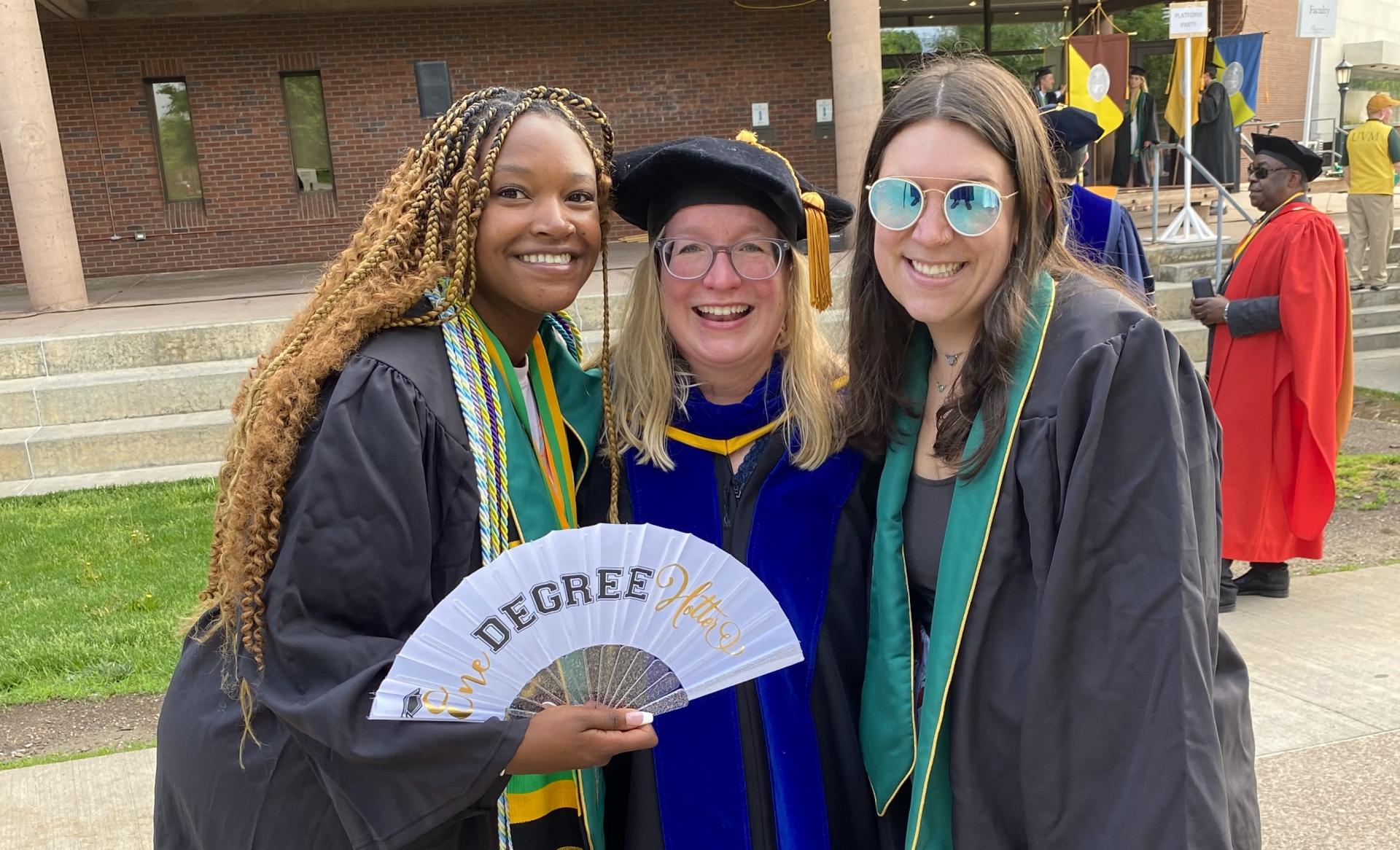 Sandra King, Professor Jen Hurley, and another student smiling before UVM Commencement.