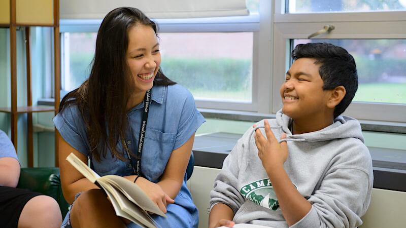 Student teacher engaging with middle school student during internship.