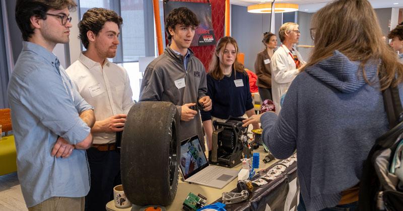 Members of the CEMS AERO club meet with an interested high school student during Discover Engineering