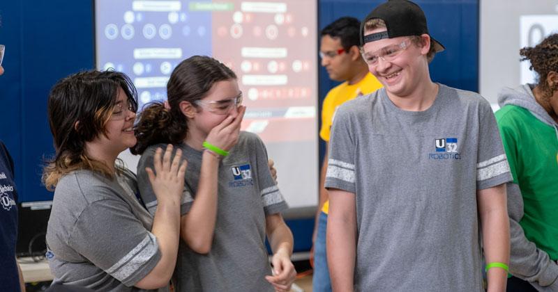 Team members share a light hearted moment during the 2024 Vermont FIRST Robotics championships