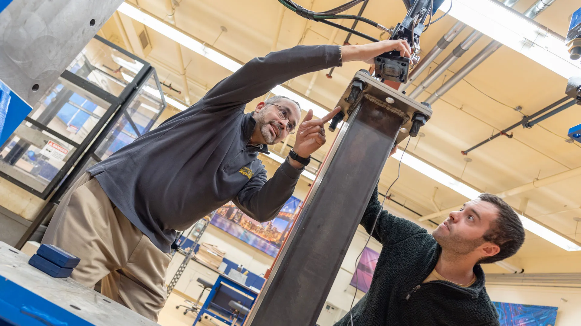 Graduate student Ben LeBlanc receives instruction from Professor Eric Hernandez in one of the Mechanical Engineering labs
