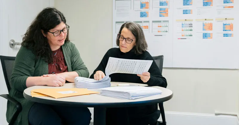 Abigail Crocker and Kathy Fox from the Justice Research Initiative review data related to their research