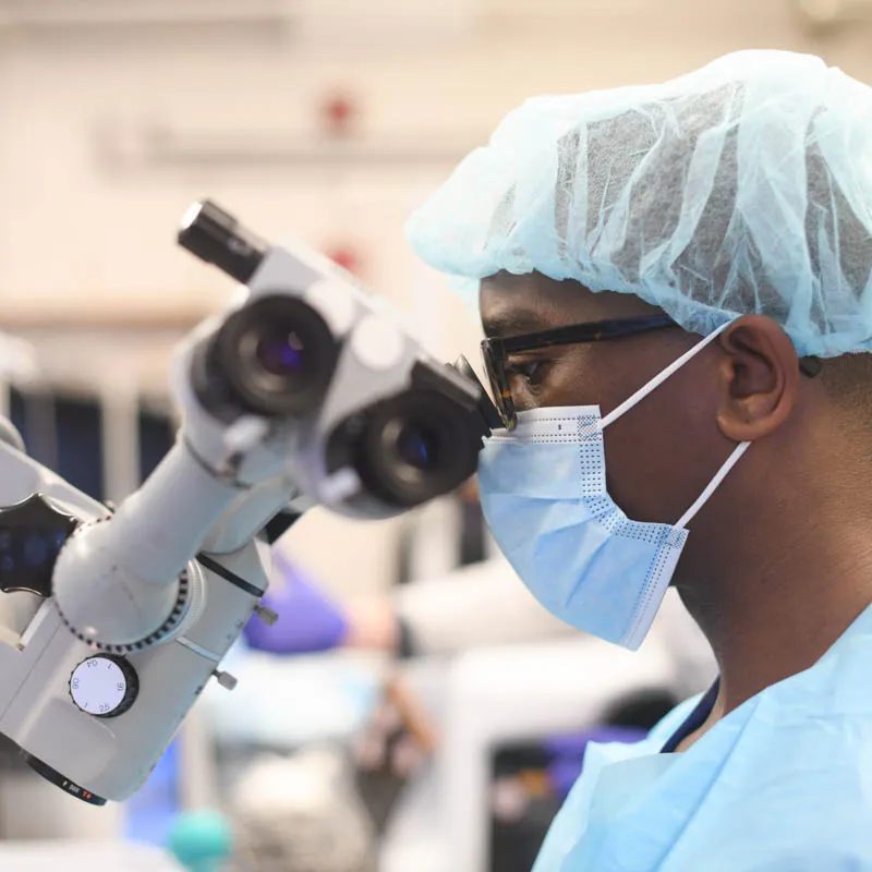 Person looking through a microscope