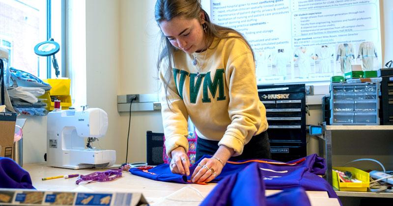 A student works on a new hospital gown prototype in the CBI