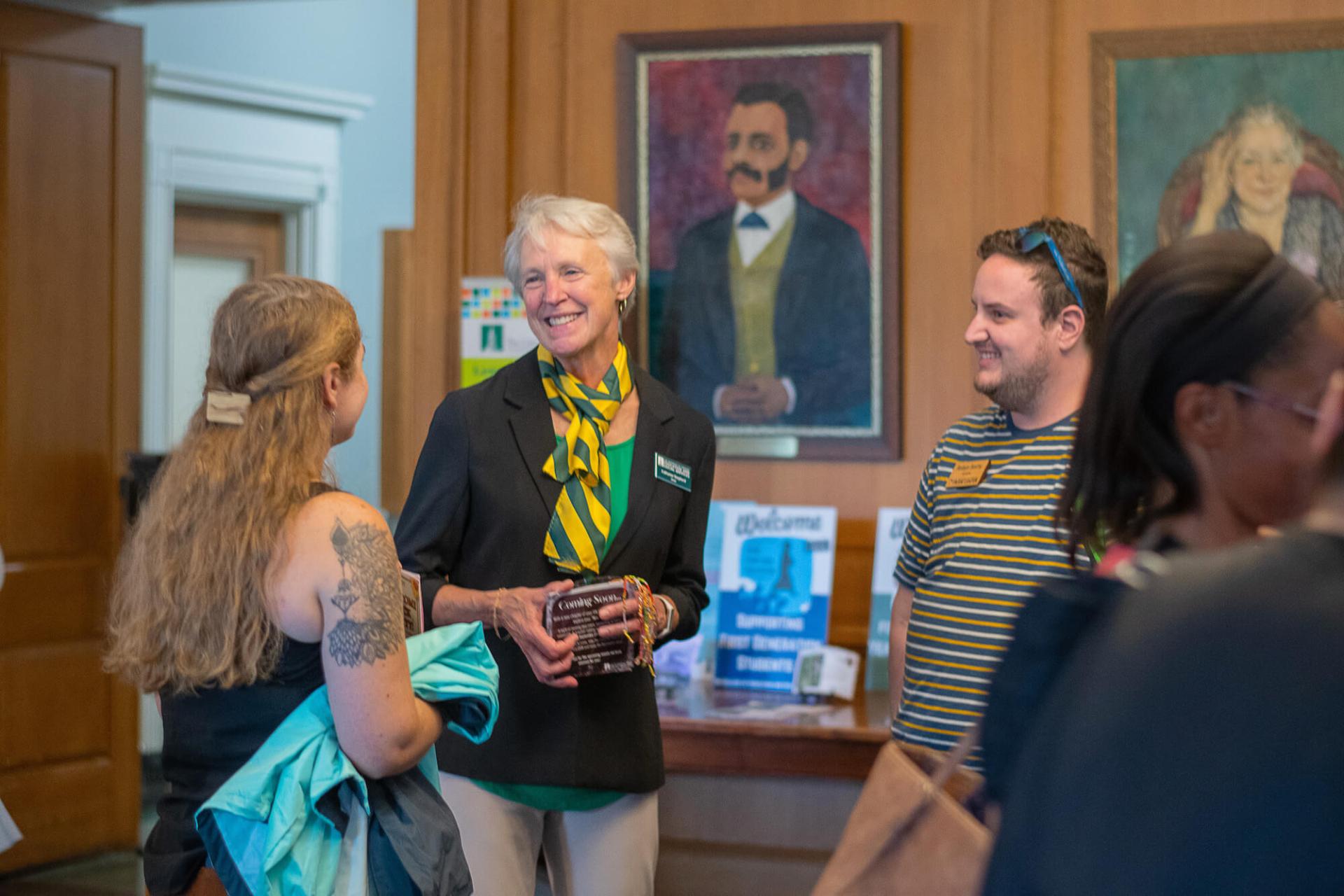 Dean Shepherd talking with new students at orientation.