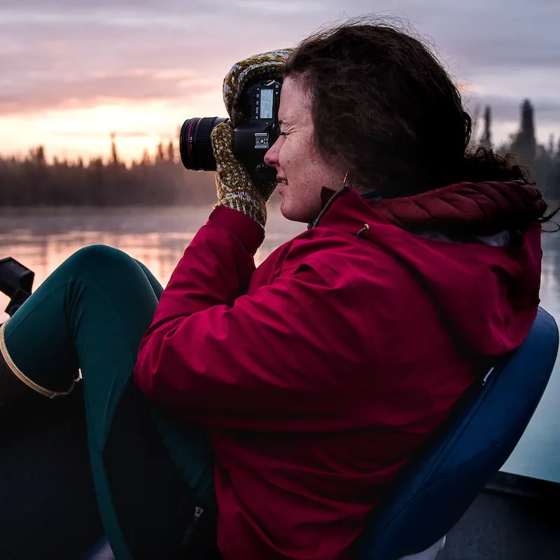 Student photographer taking photos on a boat.