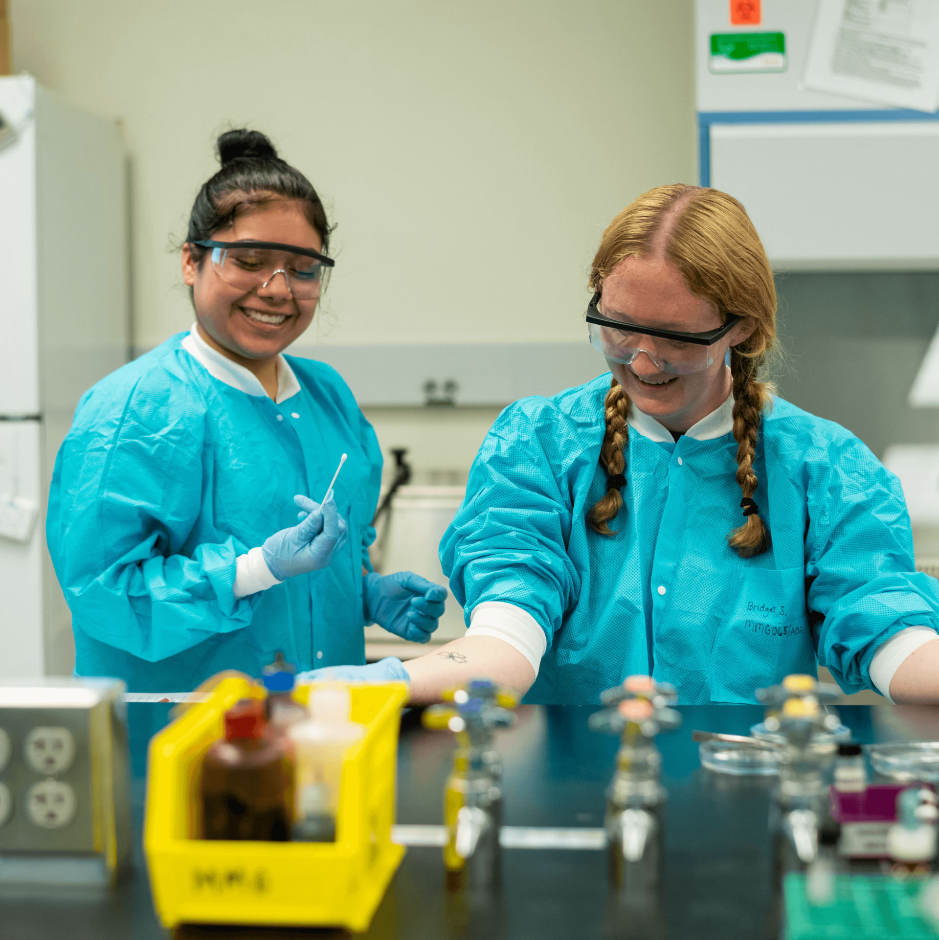 Two students in a lab doing an experiment