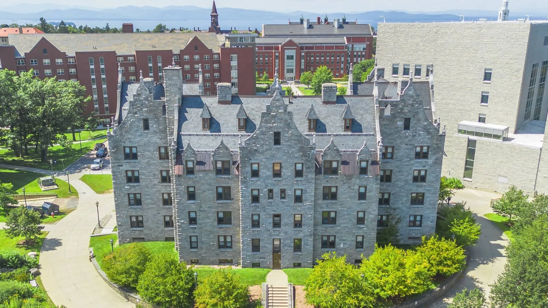 Aerial view of historic, romanesque grey stone residence hall.