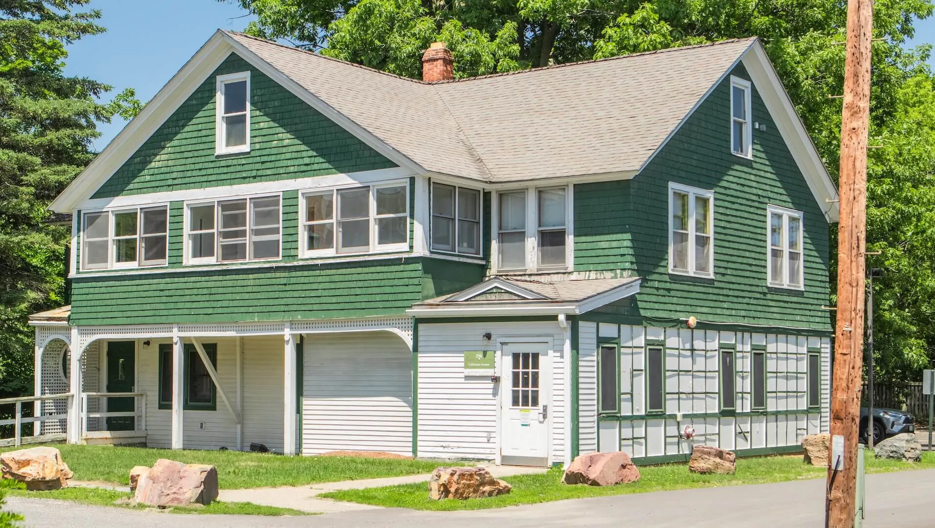 Green and white historic house-style residence hall
