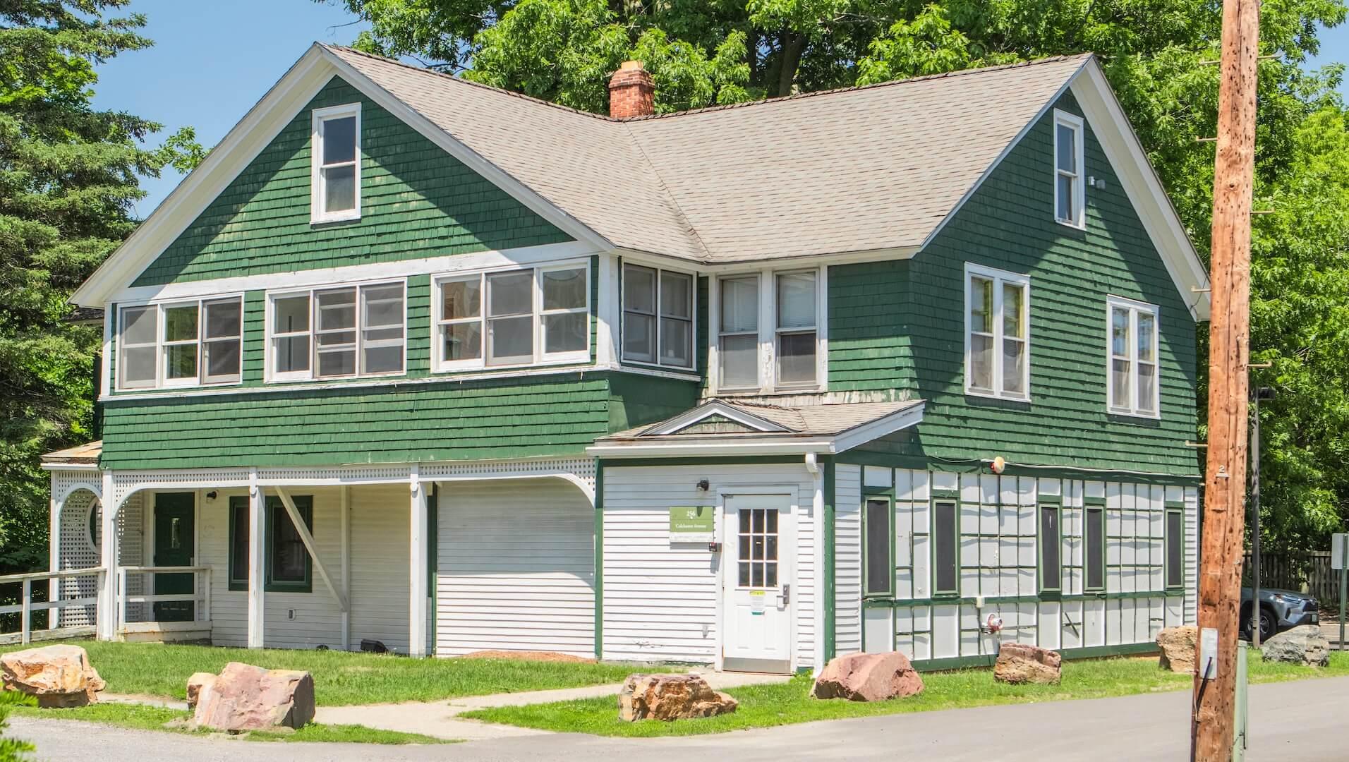 Green and white historic house-style residence hall