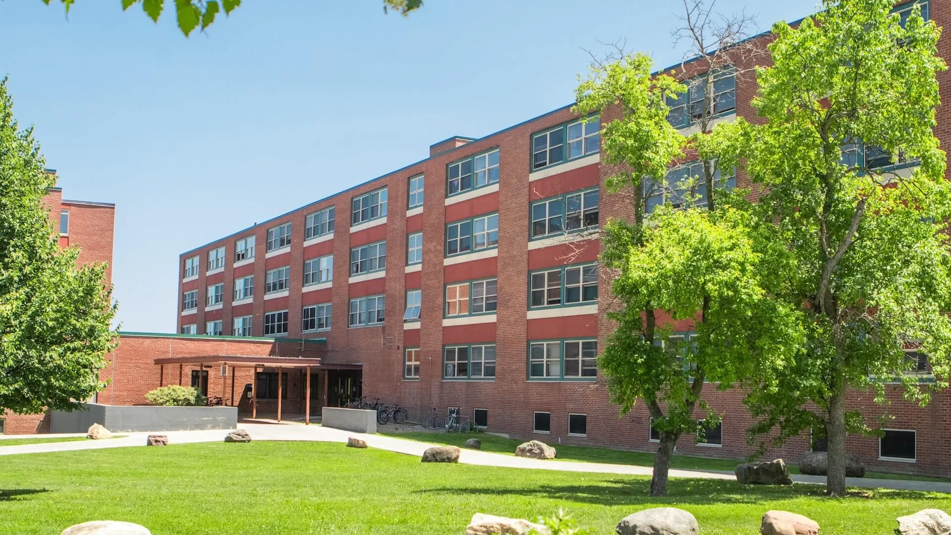 Ground view of a brick, four-story residence hall. 